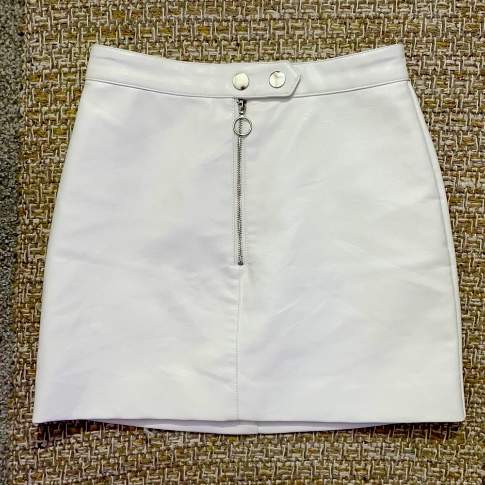 white faux leather skirt with sliver circle zipper and button